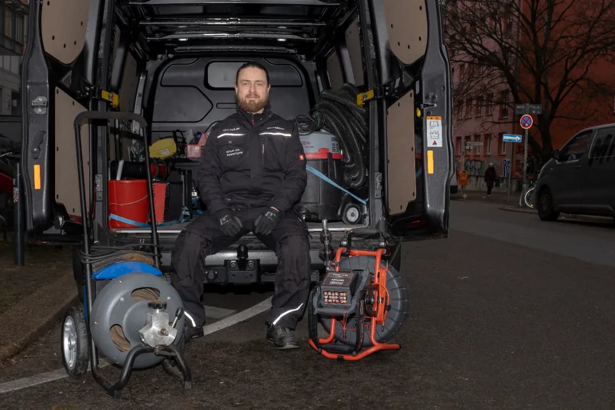Techniker installiert Rückstausicherung im Keller des Kunden